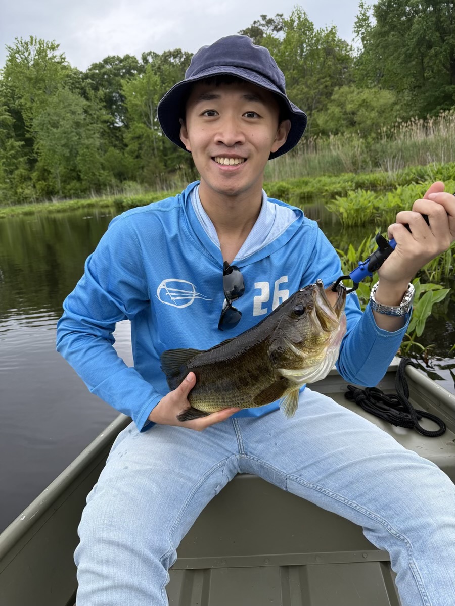 Norman Xie fishing from a small boat