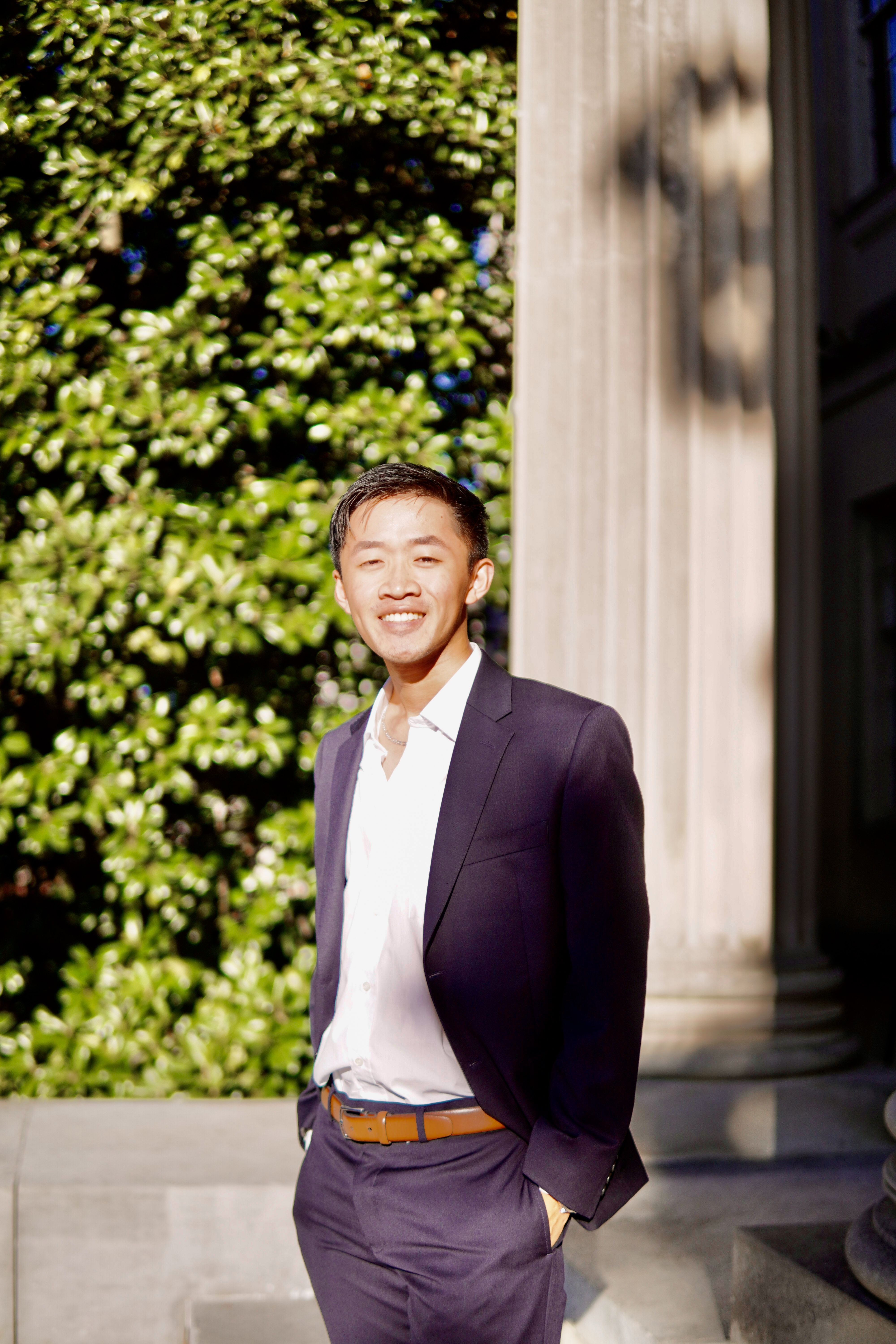Norman Xie standing outside in a suit